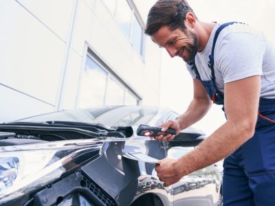 caucasian-repair-service-mechanic-choosing-colour-for-painting-car